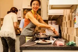 A carer practising cooking techniques